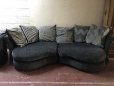 Two contemporary shaped settees in blue fabric with cushions