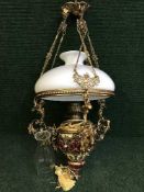 A gilt metal mounted hanging oil lamp