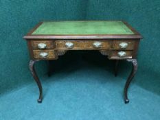 A mahogany lady's desk with tooled leather top