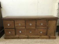 A mahogany low storage chest fitted eight drawers