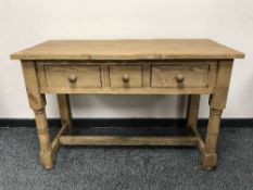 A reclaimed pine three drawer side table,