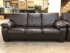 A brown leather three seater and two seater settees