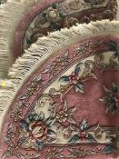 Two Chinese fringed rugs on pink ground