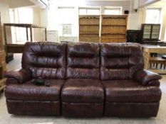 A three seater recliner settee and chair in red leather