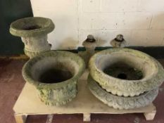 A pallet of four stone garden planters