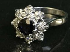 An 18ct white gold diamond and sapphire cluster ring