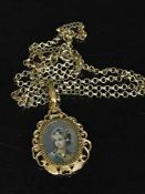 An 18ct gold pendant suspended upon a 9ct gold chain