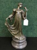 A bronze figure on marble socle - lady in flowing dress