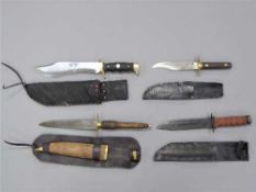 Four assorted modern fighting knives, in scabbards.