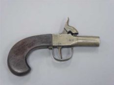 An early 19th century percussion cap pocket pistol, with 3.25cm screw off barrel and walnut grip.