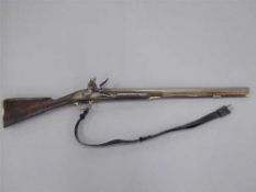 An early 19th century flintlock carbine, 68cm barrel with proof marks, with walnut stock,