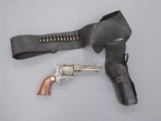 A replica Colt Single Action Army revolver, with leather holster and dummy rounds.