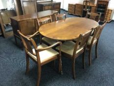 An inlaid walnut twin pedestal dining table,