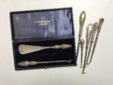 Seven assorted Art Nouveau silver handled button hooks,