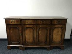 A reproduction mahogany break-front sideboard