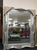 A large silvered ornate wall mirror