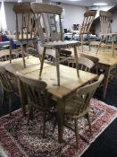 A square pine pub table and four pine chairs
