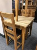 A square oak table and pair of ladder back chairs