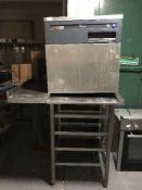 A stainless steel Whirlpool dish washer with stainless steel table and a wooden chalk board