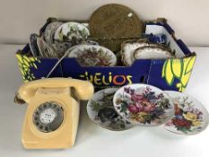 A box of Bradford exchange china plates, tea china, brass gong,