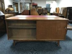 A teak sliding door bookcase