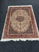 A Keshan fringed rug with silk pile on red