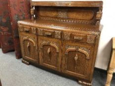 A 1920's carved oak sideboard