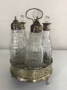 A silver four piece cruet set on stand