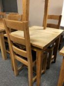 A square oak table and pair of ladder back chairs