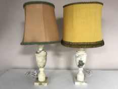 A pair of white marble table lamps with shades