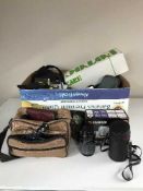 A box of cameras and equipment, flashes,