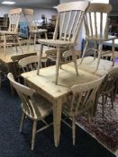 A square pine pub table and four pine chairs