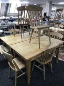 A rectangular pine pub table and four pine chairs