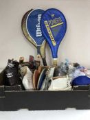 A box of golf balls, vintage ice skates, table tennis bats,