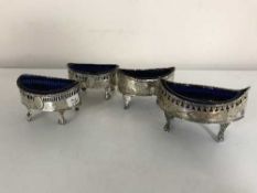 A set of four silver Georgian salts with blue glass liners