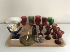 A tray of ruby tinted glasses, coloured glass, brass sundial,