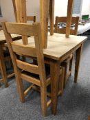 A square oak table and pair of ladder back chairs