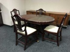 A reproduction pedestal dining table and four chairs