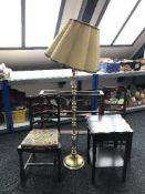 A brass standard lamp and an oak sewing table,