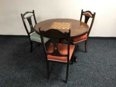 A mahogany 19th century games top table and three Edwardian dining chairs