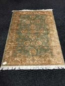 A Zeigler fringed rug with silk pile on green