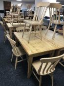 A rectangular pine pub table and four pine chairs
