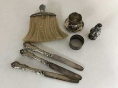 Six pieces of silver including an egg cup, napkin ring, brush,