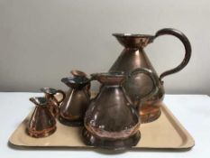A set of six antique graduated copper flaggons