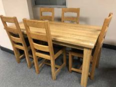A rectangular oak table and five ladder back chairs