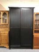 A black sliding door wardrobe