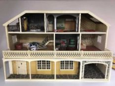 A mid twentieth century doll's house with furniture