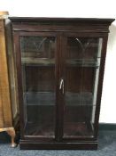 A mahogany china cabinet retailed by Chapmans of Newcastle