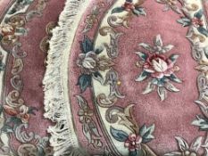 Two pink Chinese d-shaped rugs