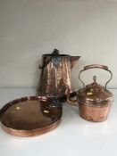 An antique copper kettle together with copper lidded pan and water carrier
